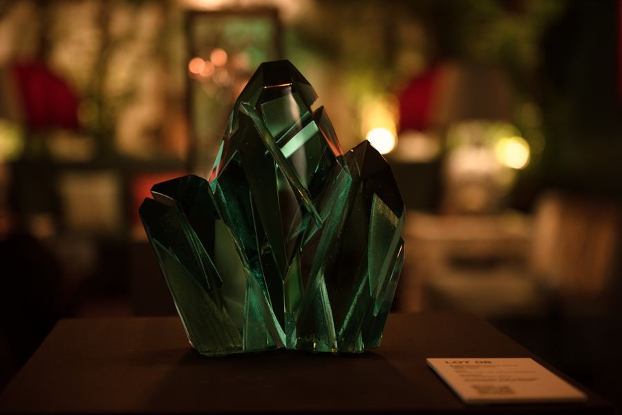 A carved green glass sculpture on display